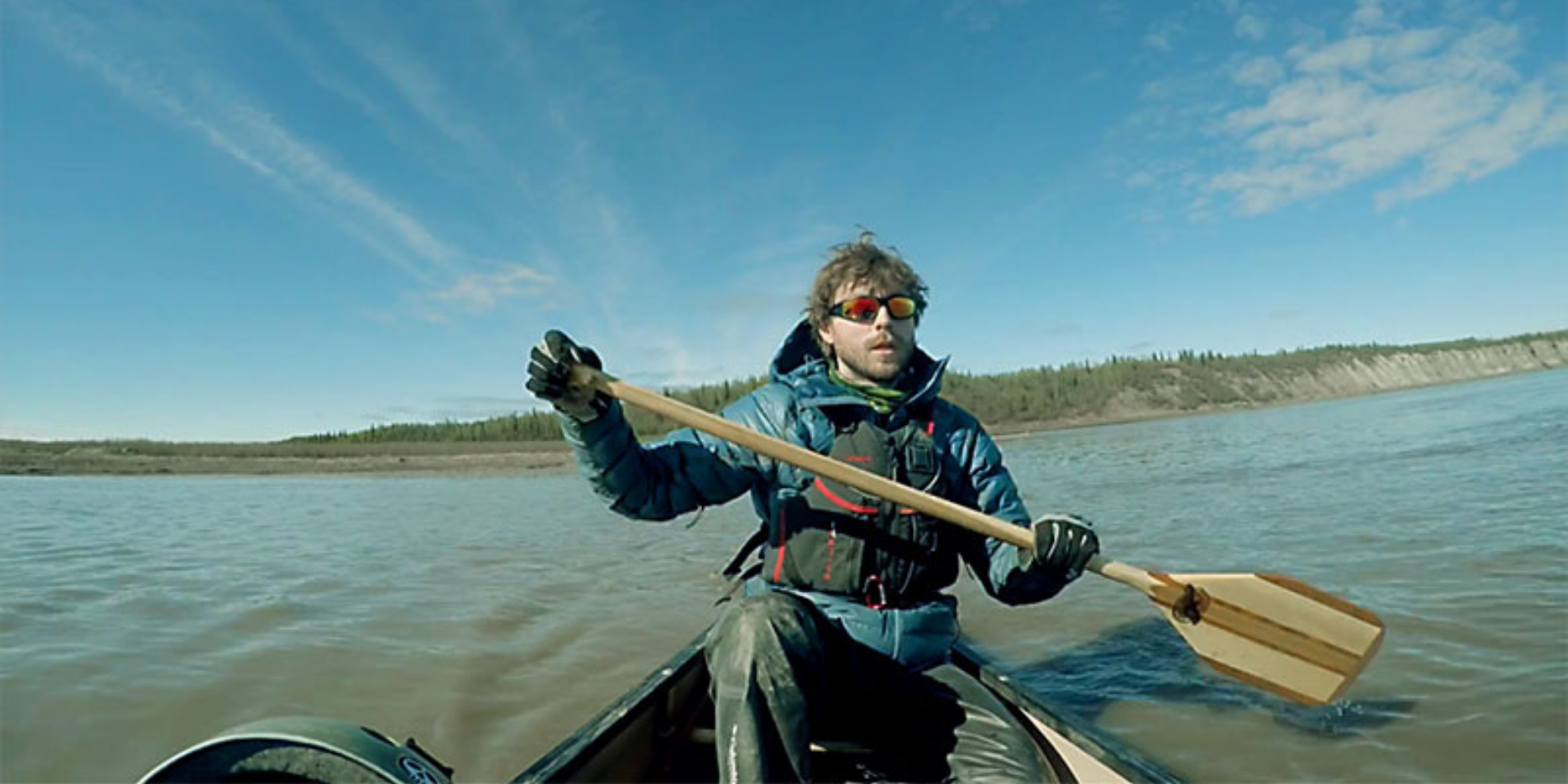 Adam Shoalts paddles down a body of water